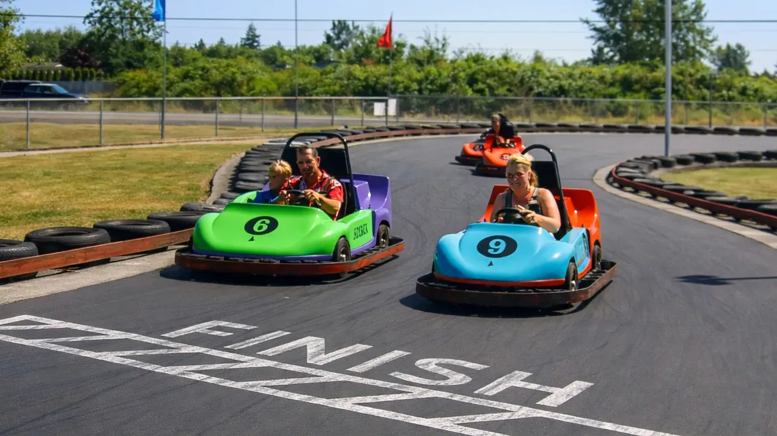 A parent and child sharing a double go-kart
